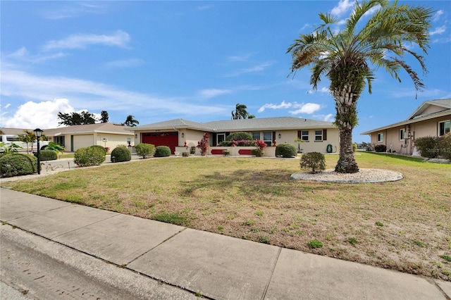 ranch-style house with driveway, a residential view, an attached garage, a front lawn, and stucco siding