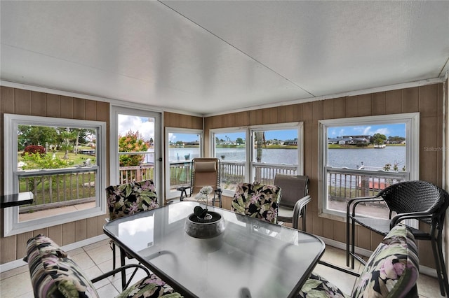 sunroom / solarium featuring a water view and a healthy amount of sunlight