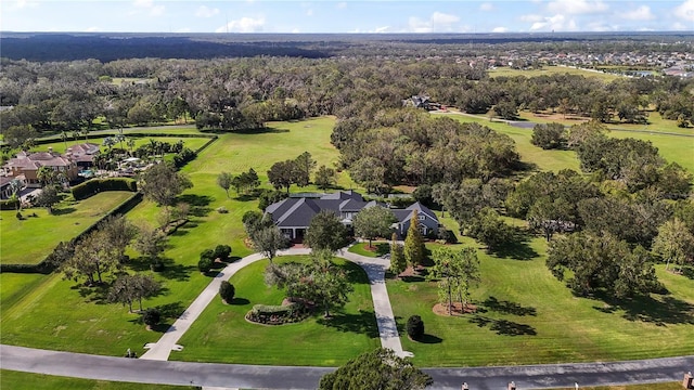 birds eye view of property featuring a view of trees