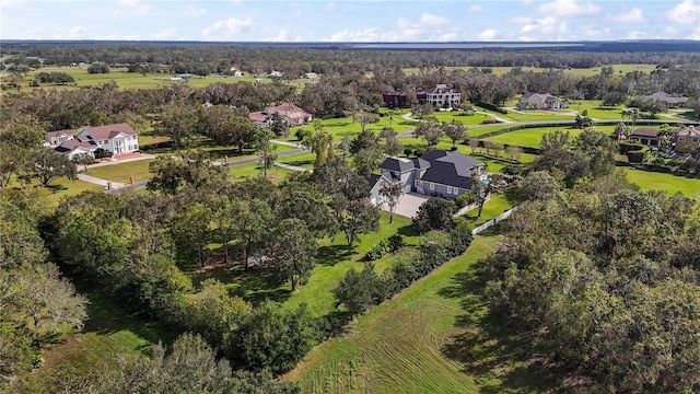 birds eye view of property featuring a forest view