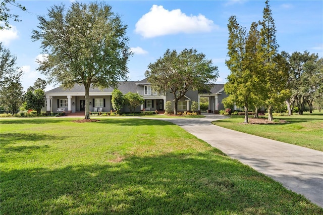 view of front of home with concrete driveway and a front lawn