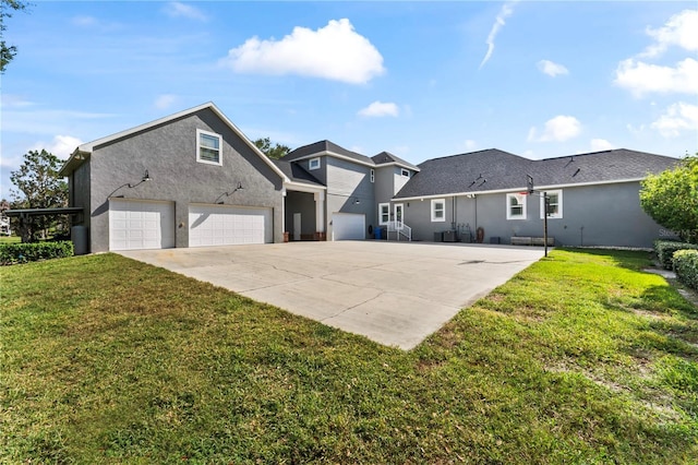 view of front of property featuring a front yard, driveway, an attached garage, and stucco siding