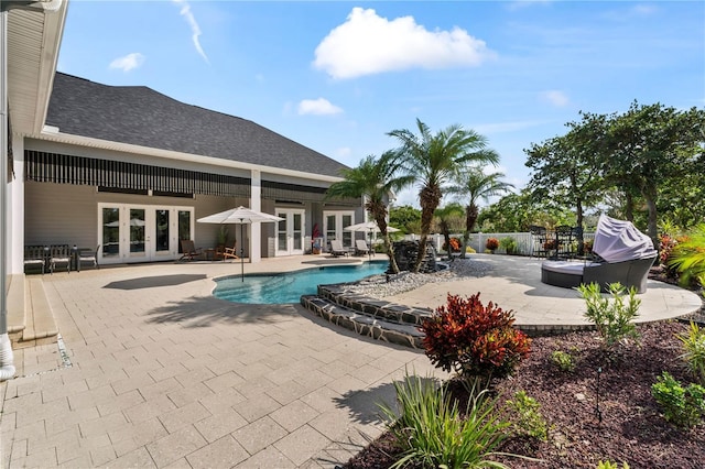 view of pool featuring a patio, french doors, fence, and a fenced in pool