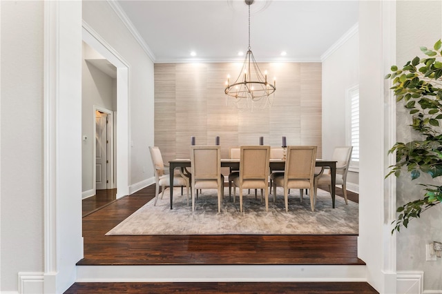 dining room featuring a notable chandelier, recessed lighting, wood finished floors, baseboards, and crown molding