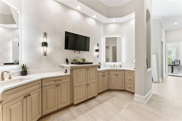 bathroom with double vanity, wallpapered walls, baseboards, and a sink