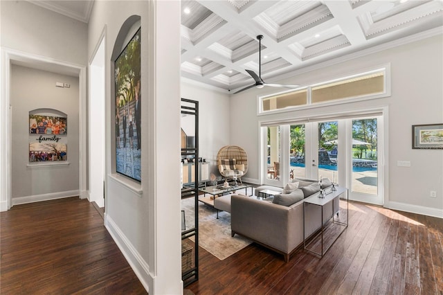 living room featuring a high ceiling, dark wood-type flooring, coffered ceiling, baseboards, and french doors