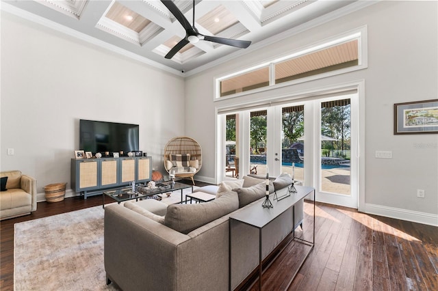 living area with dark wood-style floors, french doors, crown molding, a high ceiling, and a ceiling fan