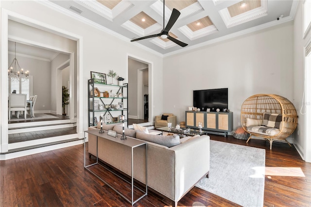 living room with ceiling fan with notable chandelier, coffered ceiling, wood finished floors, ornamental molding, and beam ceiling