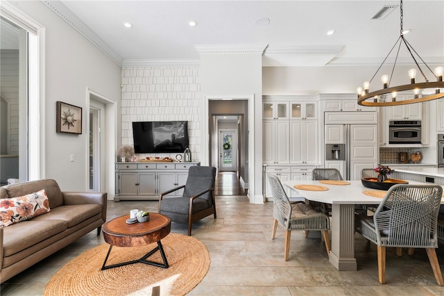 living room featuring recessed lighting, visible vents, crown molding, and an inviting chandelier