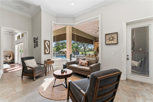 living room featuring crown molding and baseboards