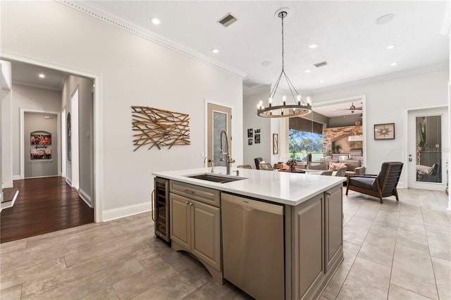 kitchen with beverage cooler, a sink, visible vents, light countertops, and stainless steel dishwasher