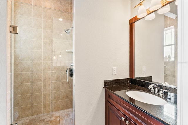 full bath with a shower stall and vanity