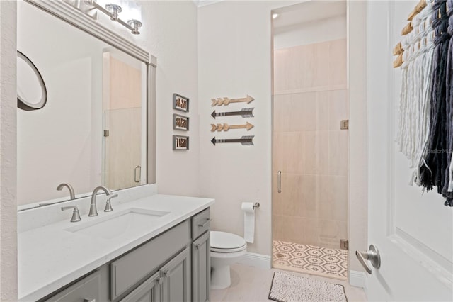 bathroom featuring toilet, tile patterned floors, a shower stall, and vanity