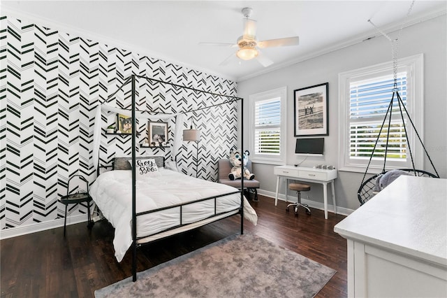 bedroom with an accent wall, dark wood-type flooring, baseboards, ornamental molding, and wallpapered walls