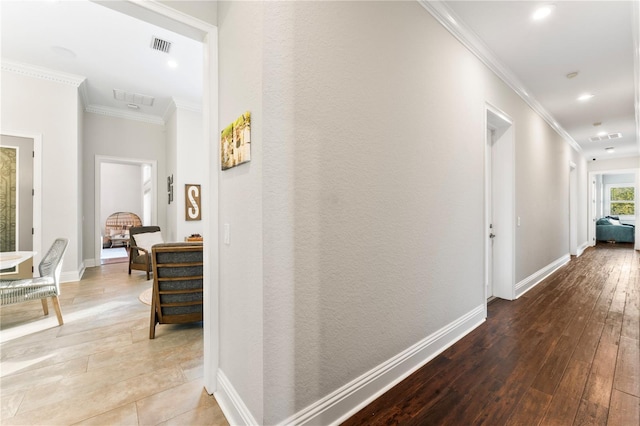 hallway featuring ornamental molding, recessed lighting, baseboards, and hardwood / wood-style floors