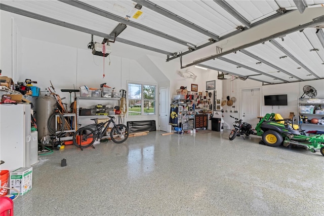 garage with a workshop area and a garage door opener