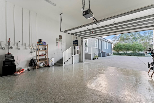 garage with a garage door opener and cooling unit