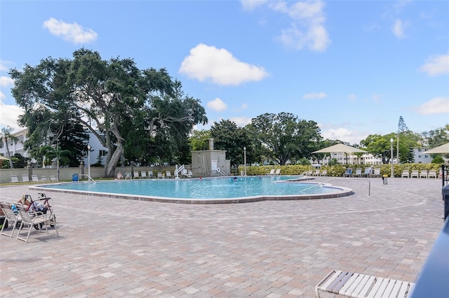 pool featuring a patio area and fence