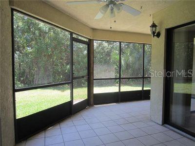 unfurnished sunroom with ceiling fan