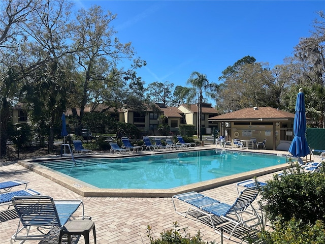 pool featuring a patio and fence