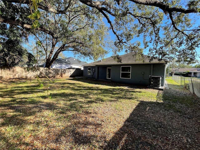 exterior space with a fenced backyard and central AC unit