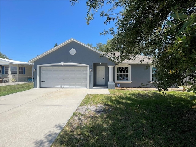 ranch-style home with stucco siding, driveway, and a garage
