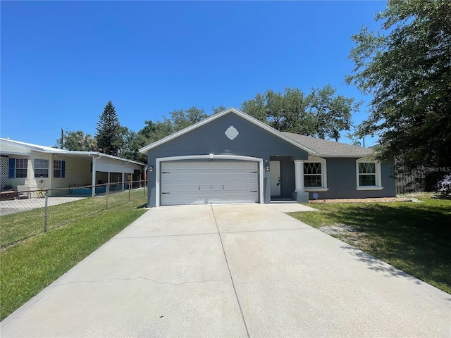 ranch-style home featuring an attached garage, driveway, and stucco siding