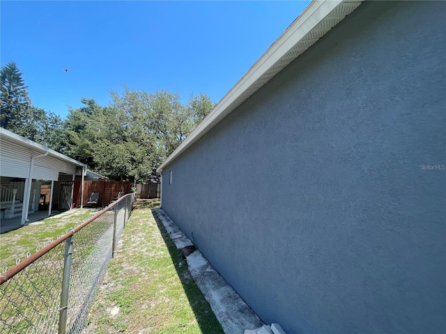 view of side of home with stucco siding