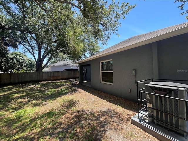 view of yard with fence and cooling unit