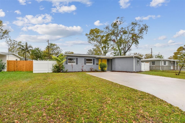 view of front of property with a front yard, driveway, and fence