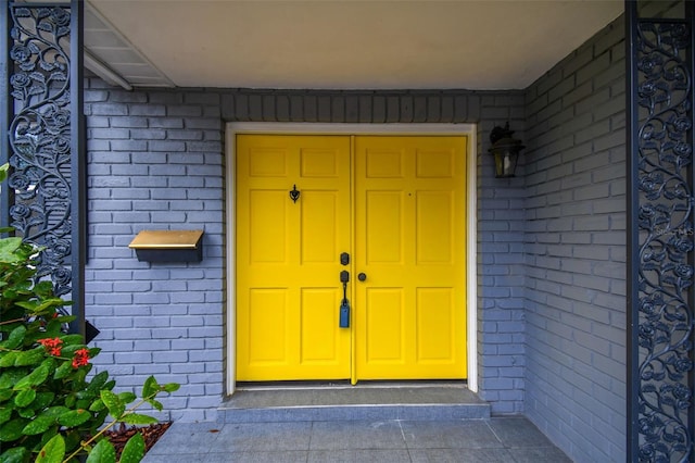 property entrance with brick siding