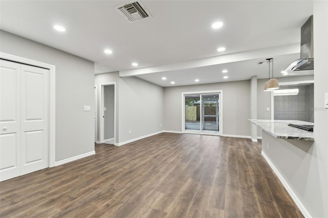 unfurnished living room featuring recessed lighting, visible vents, dark wood finished floors, and baseboards