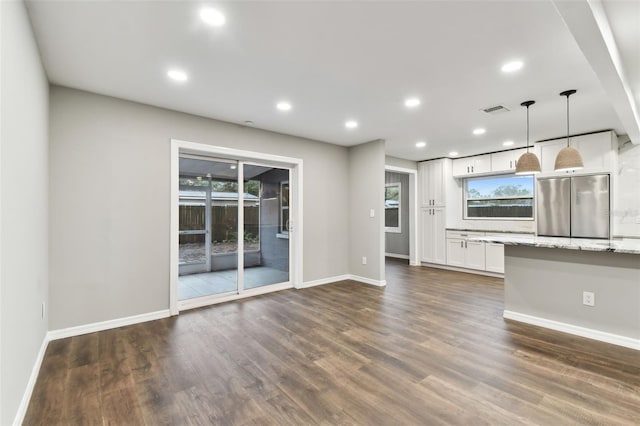 unfurnished living room featuring recessed lighting, dark wood-style flooring, visible vents, and baseboards