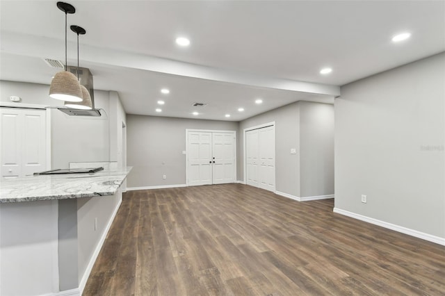 unfurnished living room with dark wood-style flooring, recessed lighting, visible vents, and baseboards