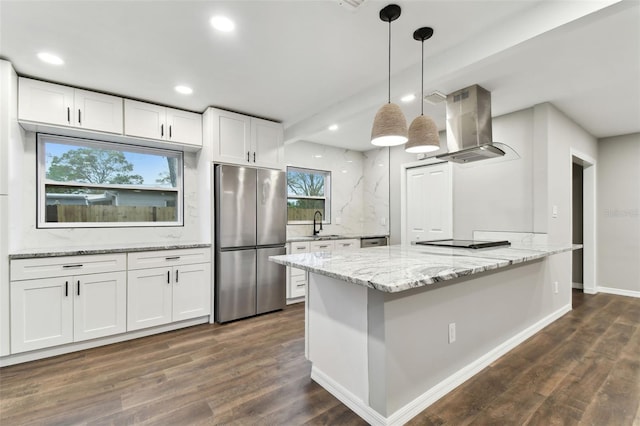 kitchen featuring freestanding refrigerator, pendant lighting, white cabinetry, and island exhaust hood