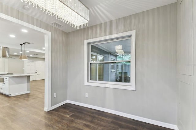 unfurnished dining area with dark wood-style floors, recessed lighting, visible vents, and baseboards