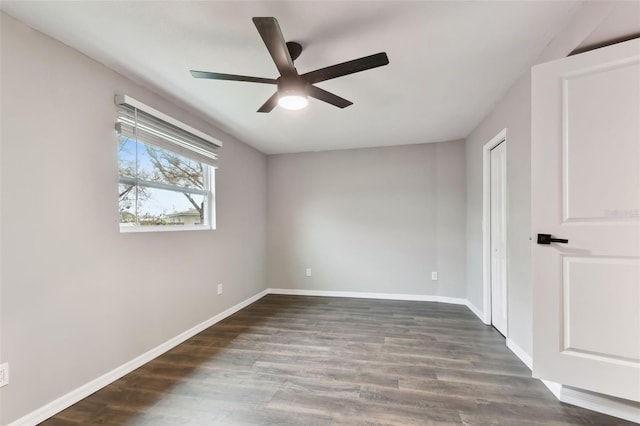 unfurnished bedroom with dark wood-style floors, a closet, baseboards, and a ceiling fan