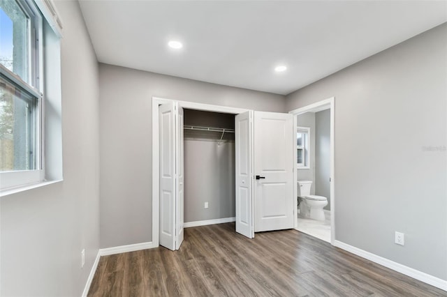 unfurnished bedroom featuring recessed lighting, a closet, baseboards, and wood finished floors