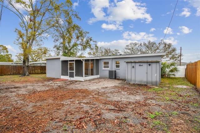 rear view of house featuring a sunroom, a fenced backyard, and central air condition unit