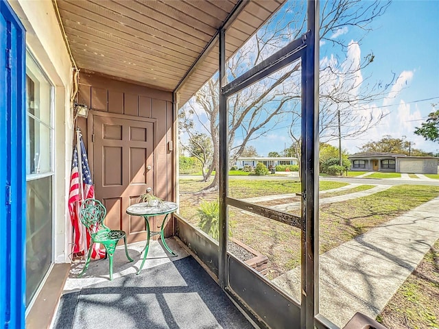 unfurnished sunroom with wooden ceiling