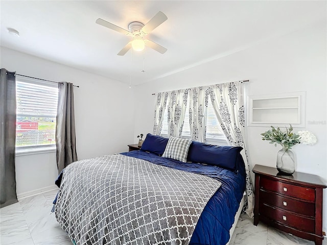 bedroom featuring marble finish floor and ceiling fan