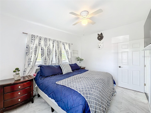 bedroom with marble finish floor and a ceiling fan