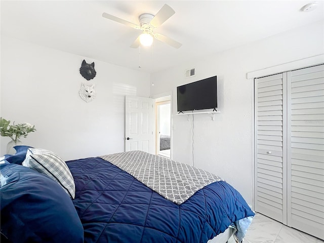 bedroom with marble finish floor, visible vents, and a ceiling fan