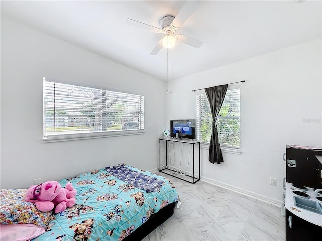 bedroom with a ceiling fan, marble finish floor, and baseboards