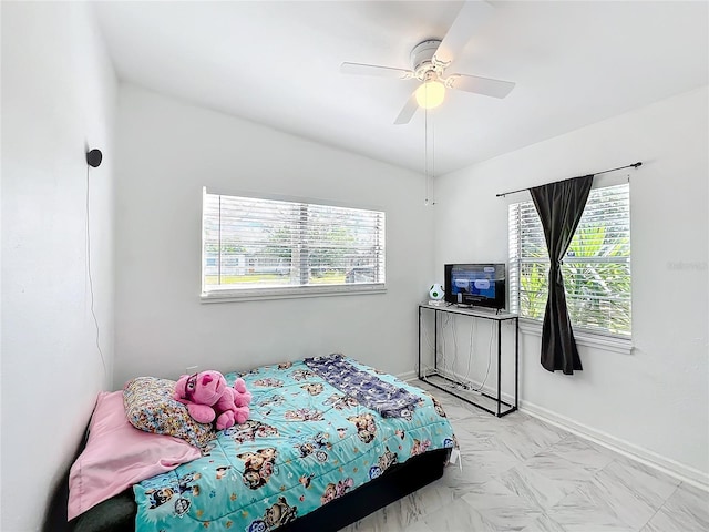 bedroom with ceiling fan and baseboards