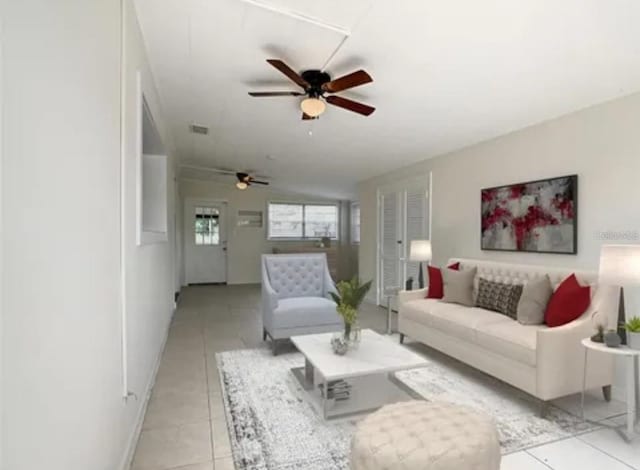 living room with light tile patterned floors, ceiling fan, and visible vents