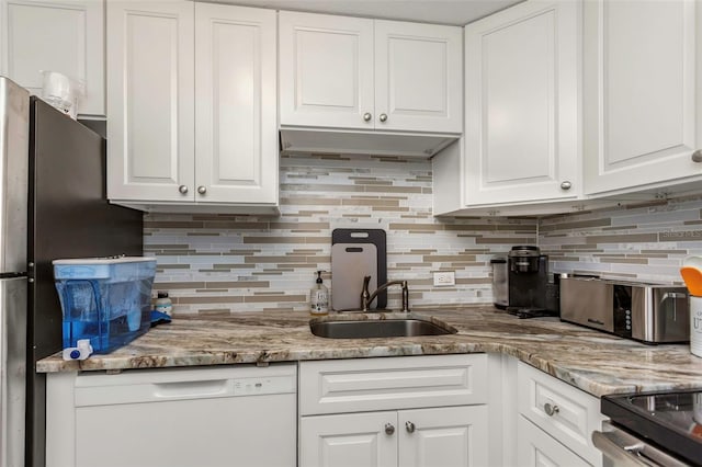 kitchen with white cabinets, white dishwasher, backsplash, and a sink