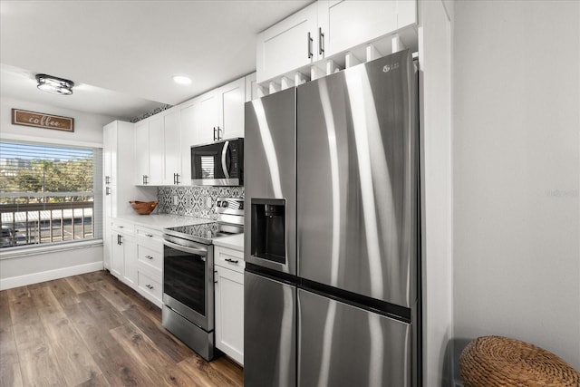 kitchen featuring stainless steel appliances, light countertops, white cabinets, and dark wood finished floors