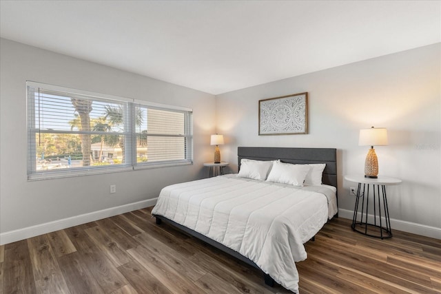 bedroom featuring dark wood-type flooring and baseboards