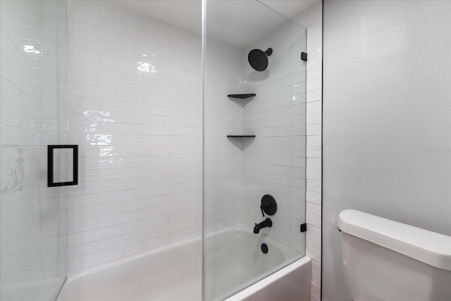 full bath featuring a textured wall, shower / bath combination with glass door, and toilet